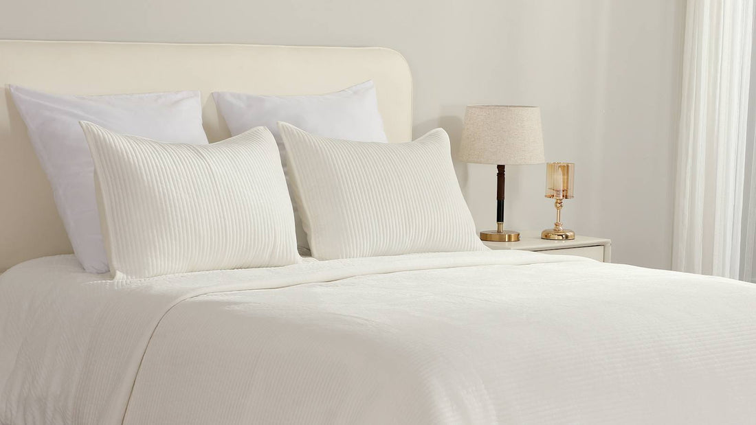 Layered white bedding with ribbed texture